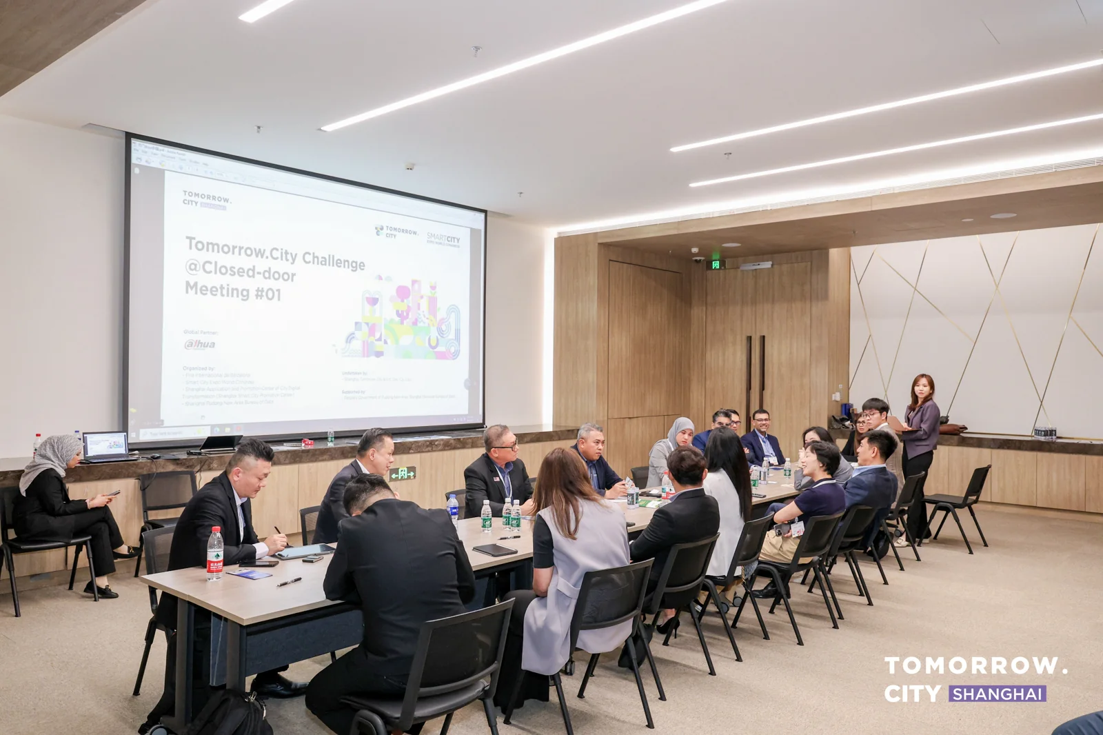 International delegates discussing cooperation needs at a Tomorrow.City Shanghai 2025 project meeting